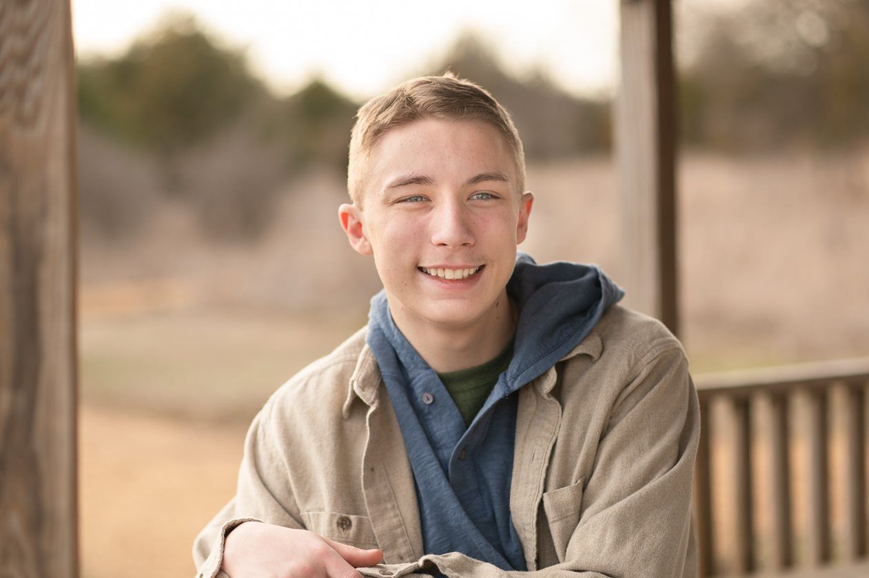 Senior guy portrait session in a late winter field and with his car by Kristi Bray Photography