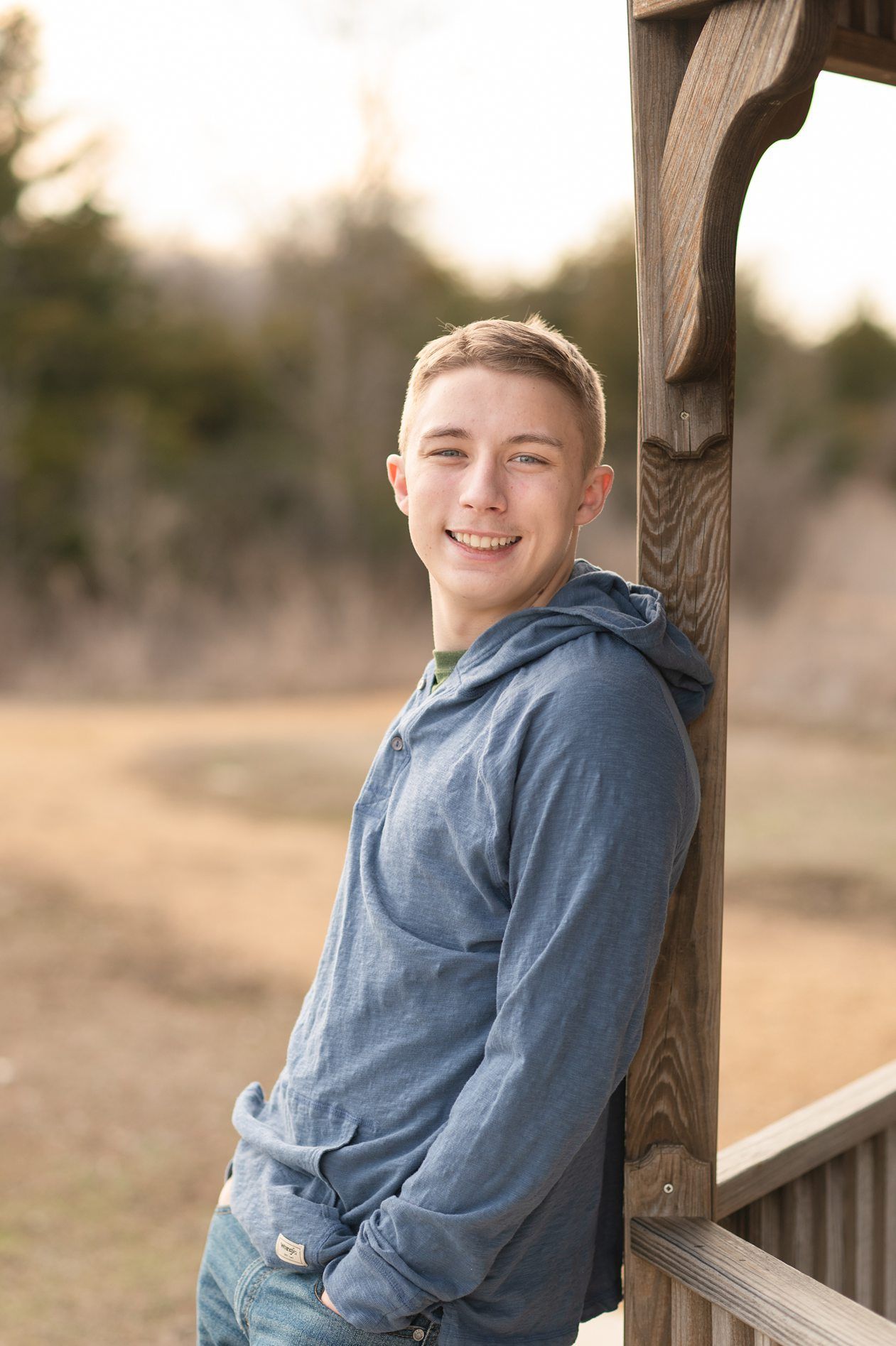 Senior guy portrait session in a late winter field and with his car by Kristi Bray Photography