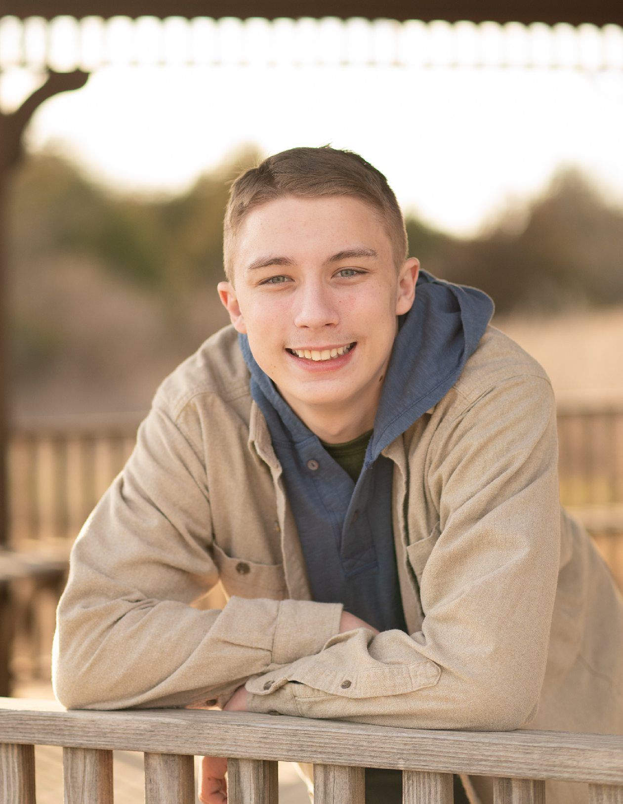 Senior guy portrait session in a late winter field and with his car by Kristi Bray Photography