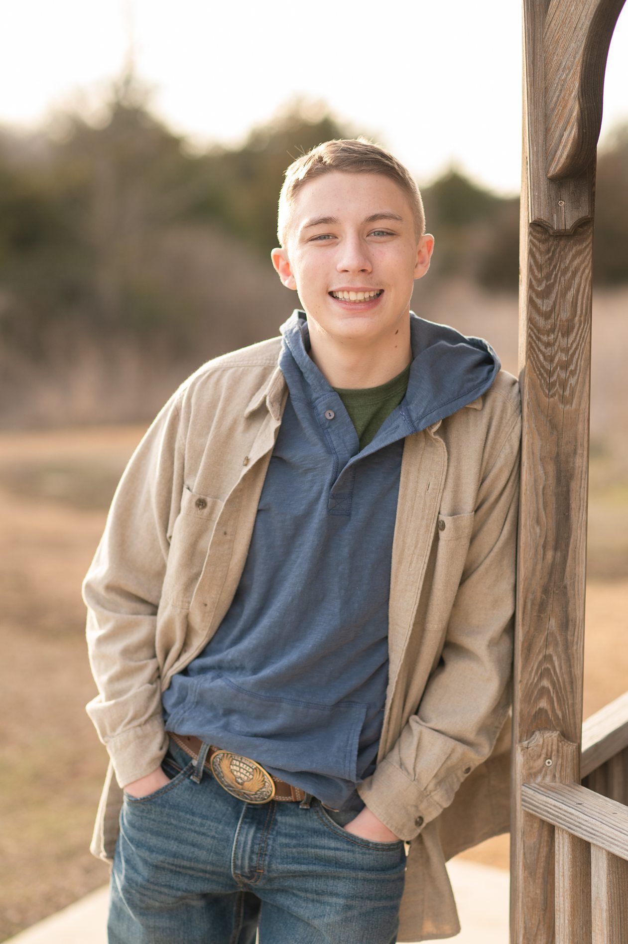 Senior guy portrait session in a late winter field and with his car by Kristi Bray Photography