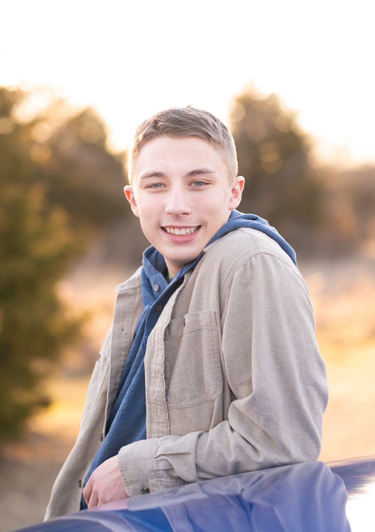 Senior guy portrait session in a late winter field and with his car by Kristi Bray Photography