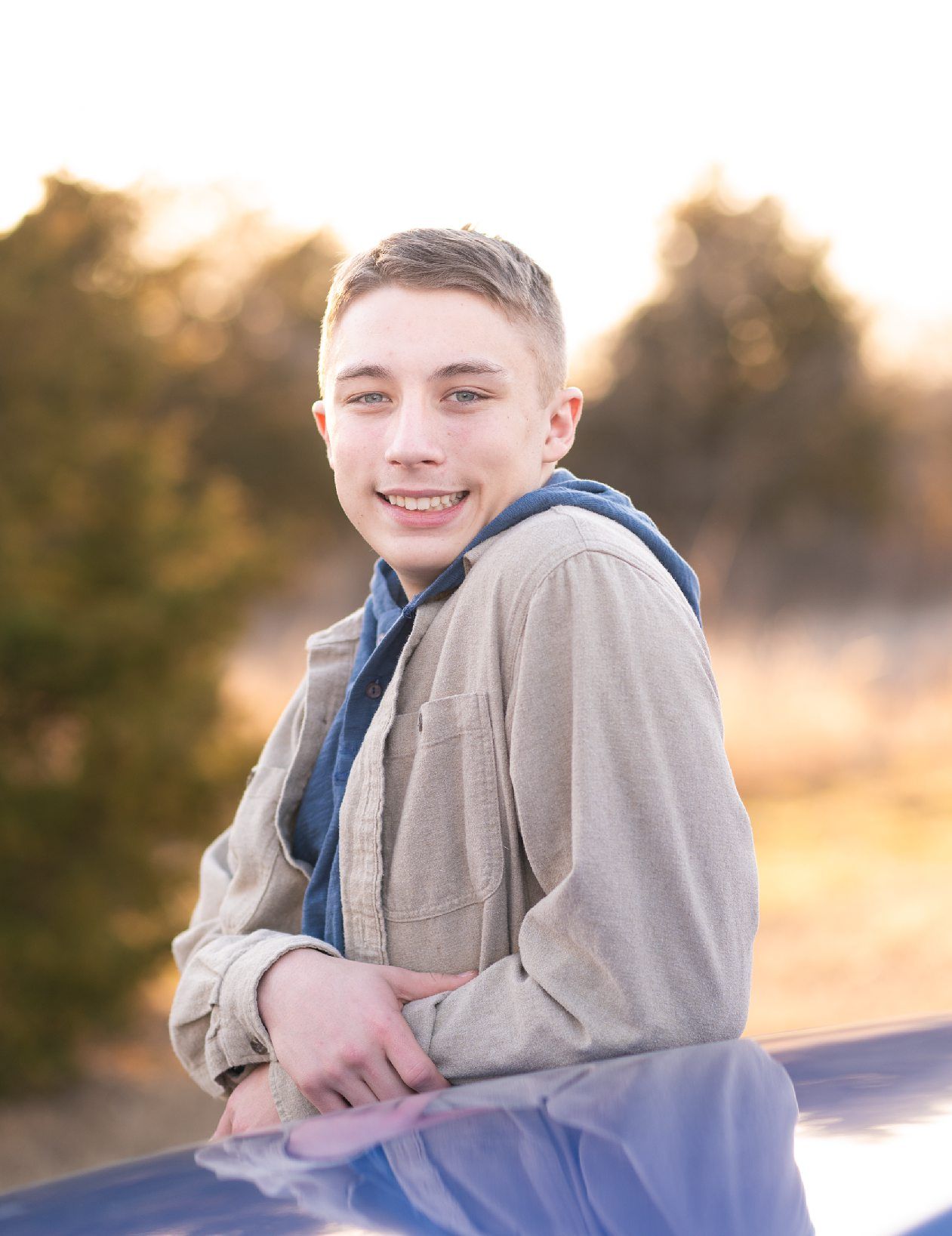 Senior guy portrait session in a late winter field and with his car by Kristi Bray Photography