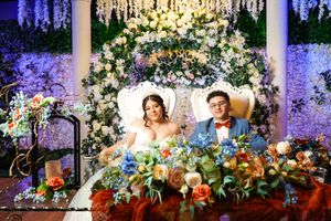 Stunning wedding decor collage featuring luxurious floral arrangements, crystal chandeliers, and romantic purple lighting effects.