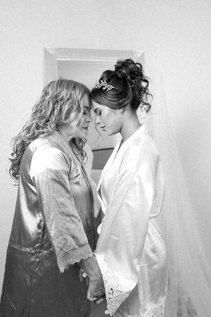A romantic black and white photo series shows an intimate moment between a couple in wedding attire.