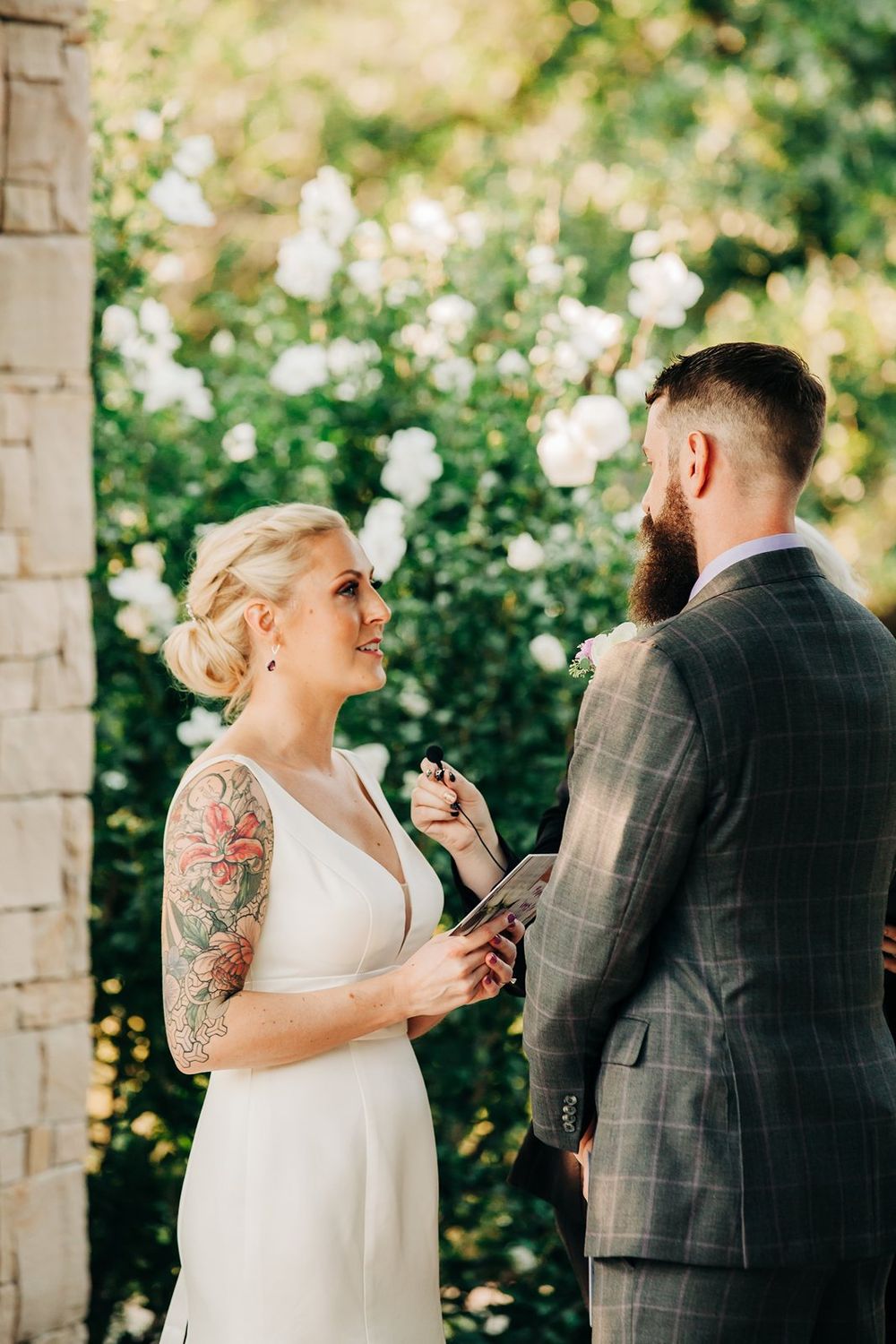 A couple shares an intimate moment during their garden wedding ceremony.