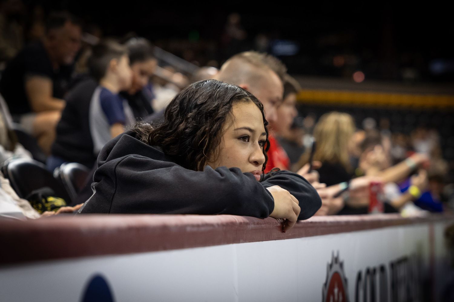 BJJ fans watch intently from matside seats during an intense match moment.