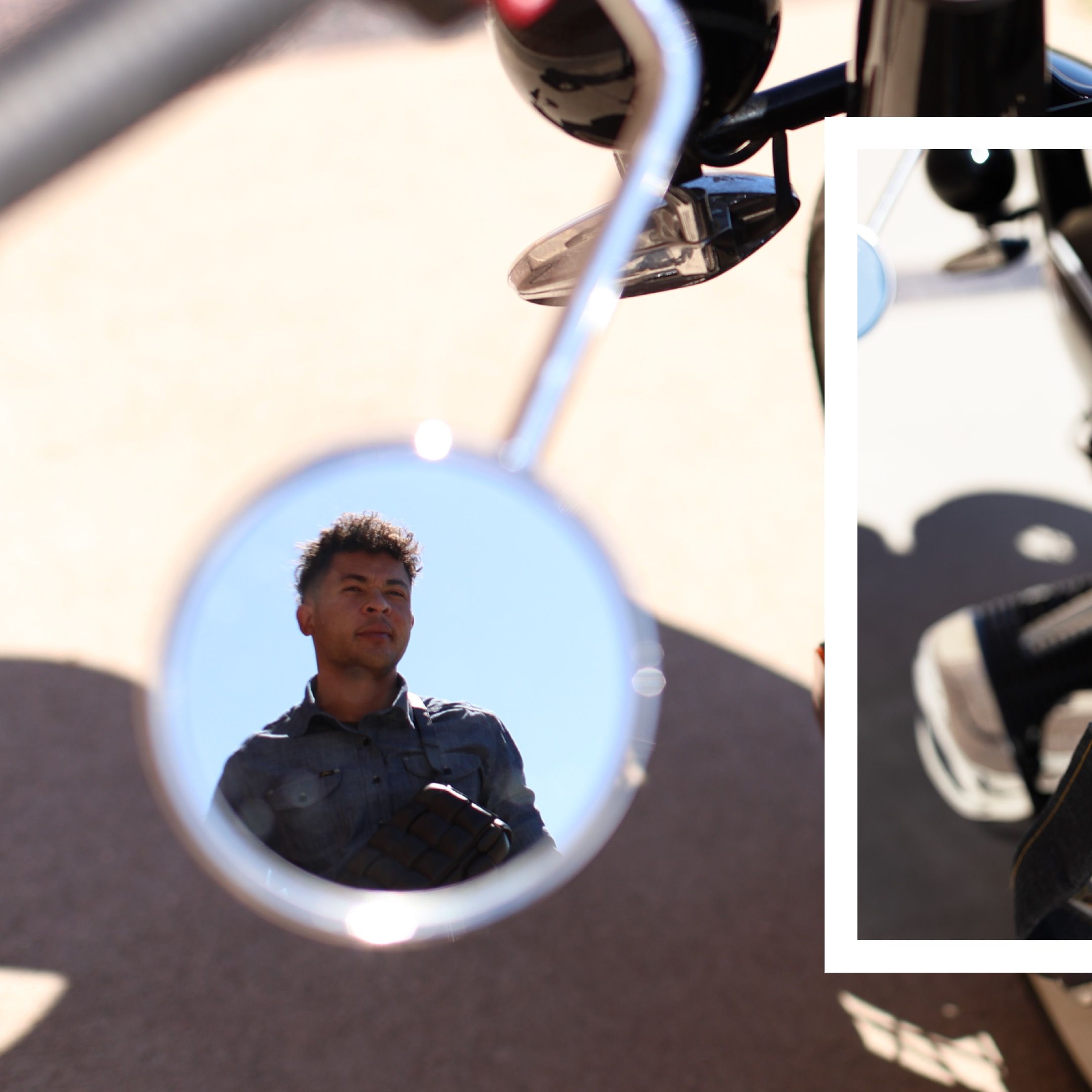 A motorcycle side mirror reflection shows a rider against a bright background.