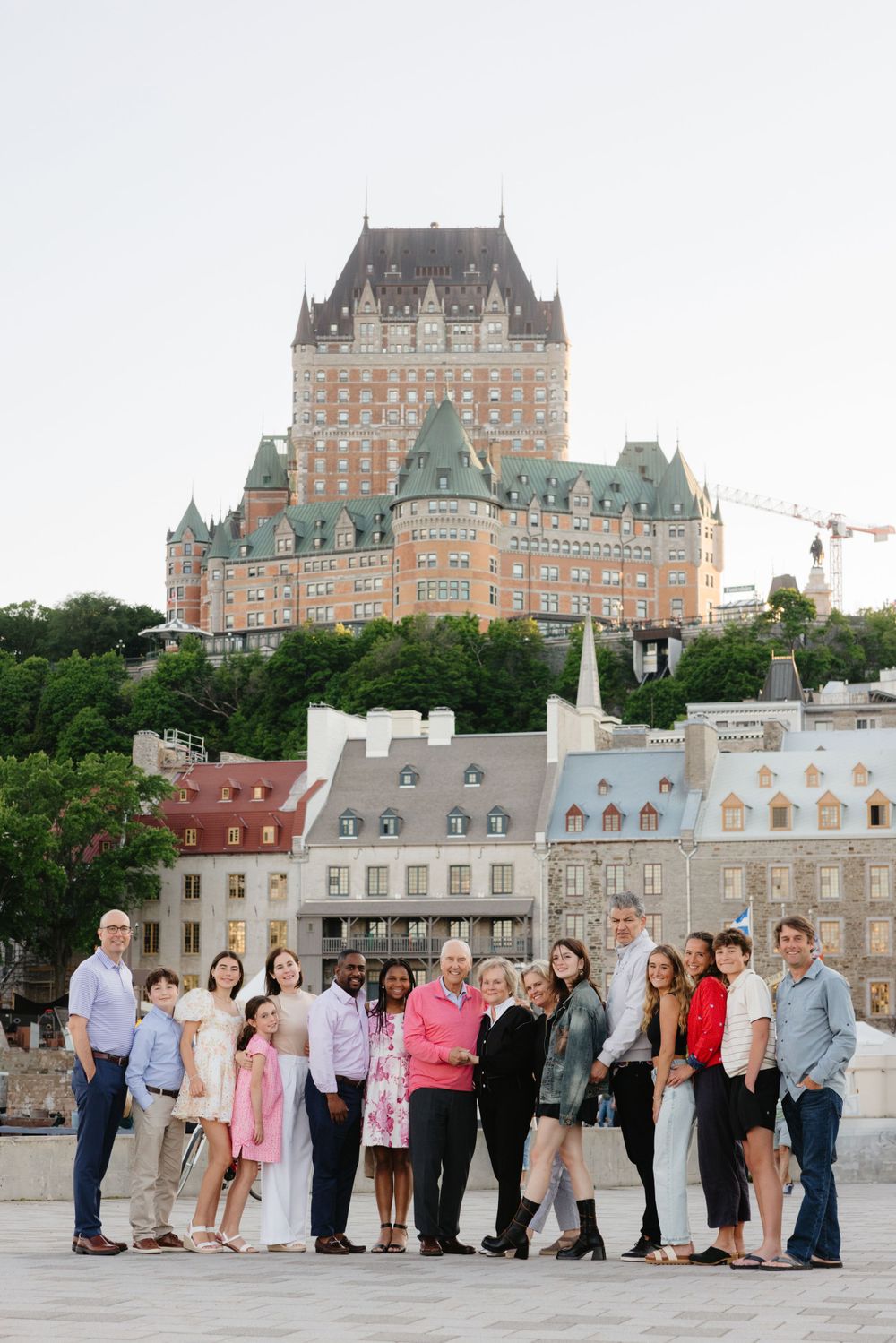 A group poses together in front of the historic Chateau Frontenac hotel in Quebec City, Canada.