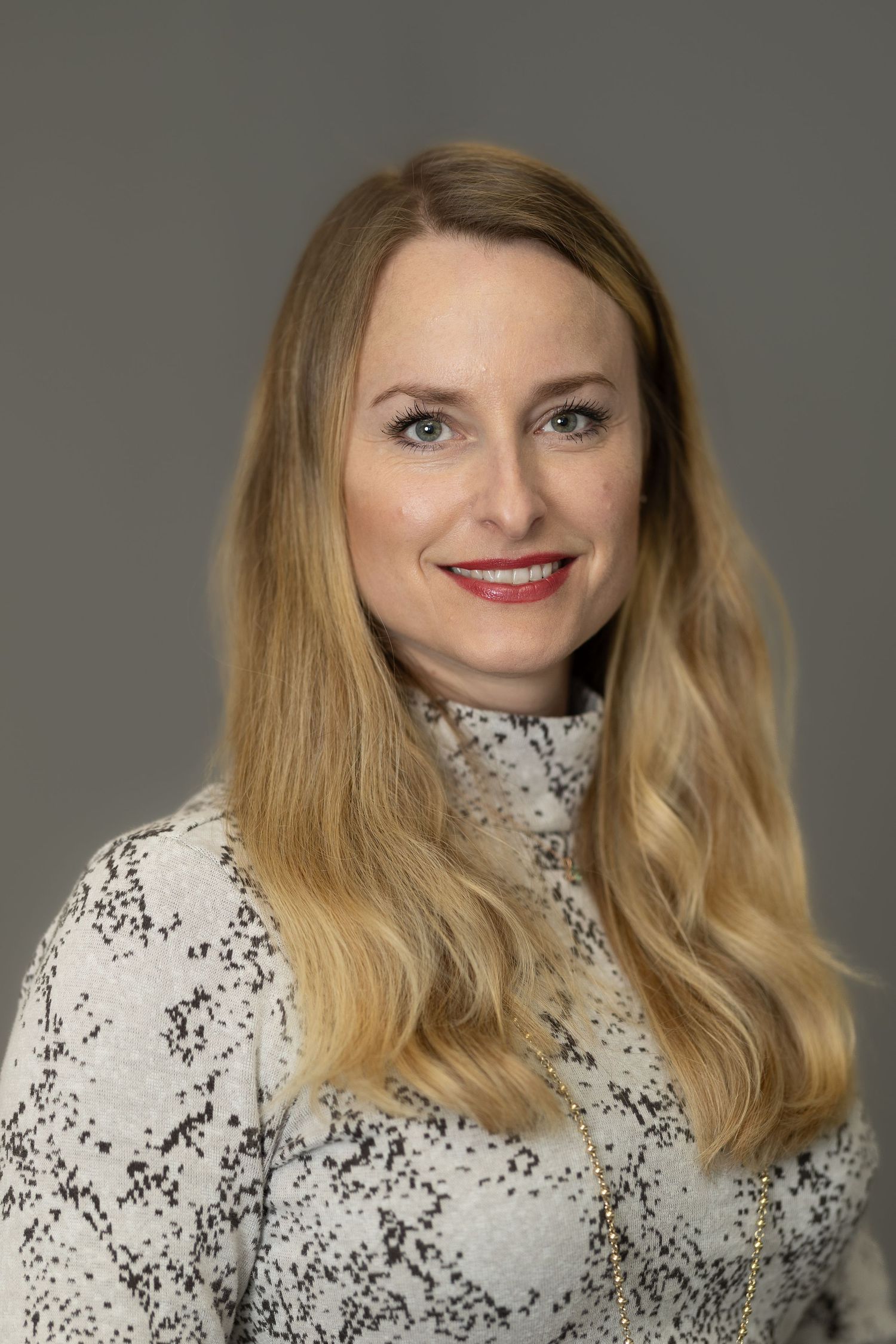 Portrait series showing different angles of someone wearing a high-neck white and black speckled sweater.
