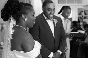 A beautiful wedding ceremony captured in black and white with the couple at the altar.