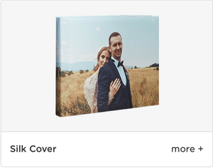 A couple embraces in a golden wheat field on a canvas wrapped in silk photo cover.