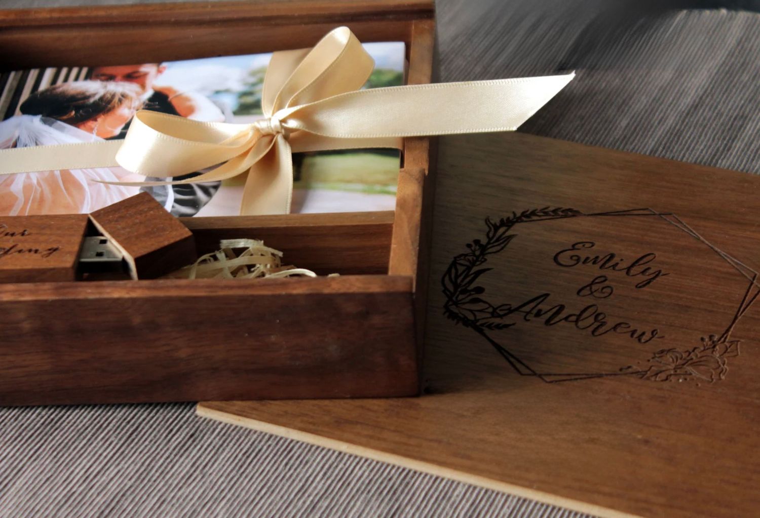 Wooden keepsake box with ribbon and custom engraved design on lid.