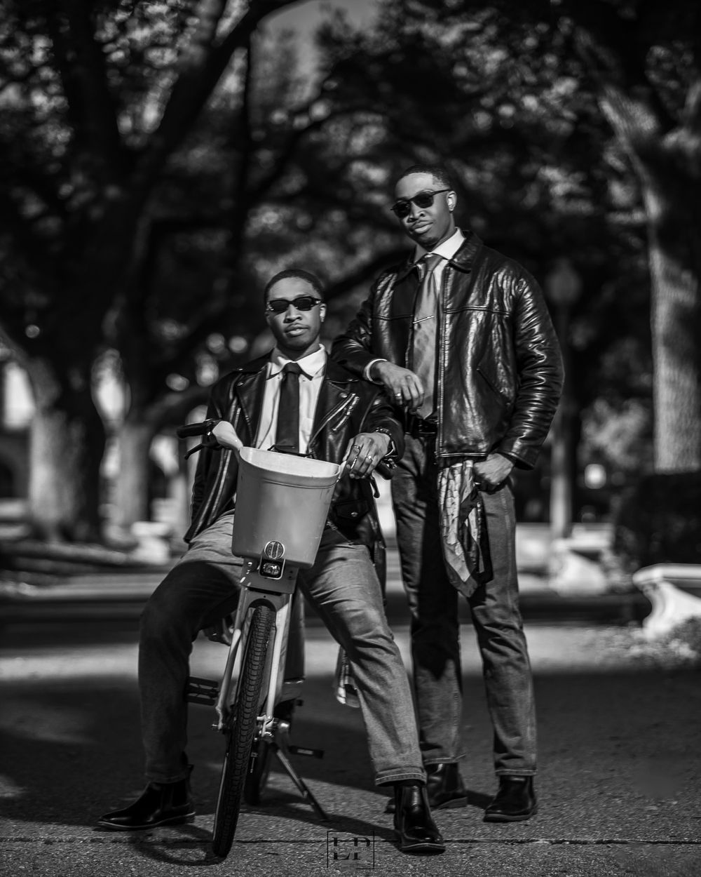 Black and white street photography of musicians with instruments in urban setting.