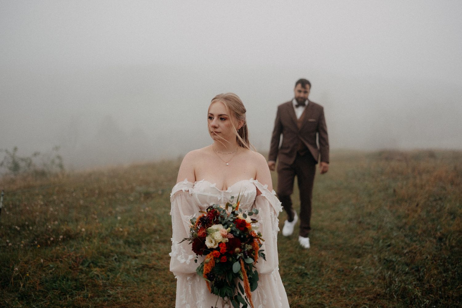 A romantic outdoor photoshoot captures tender moments between a couple in a sunlit wooded setting.