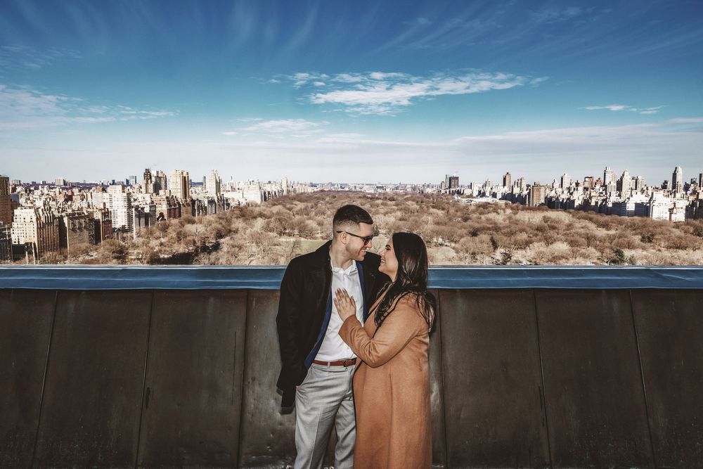 Romantic cityscape photoshoot with New York City skyline in the background.