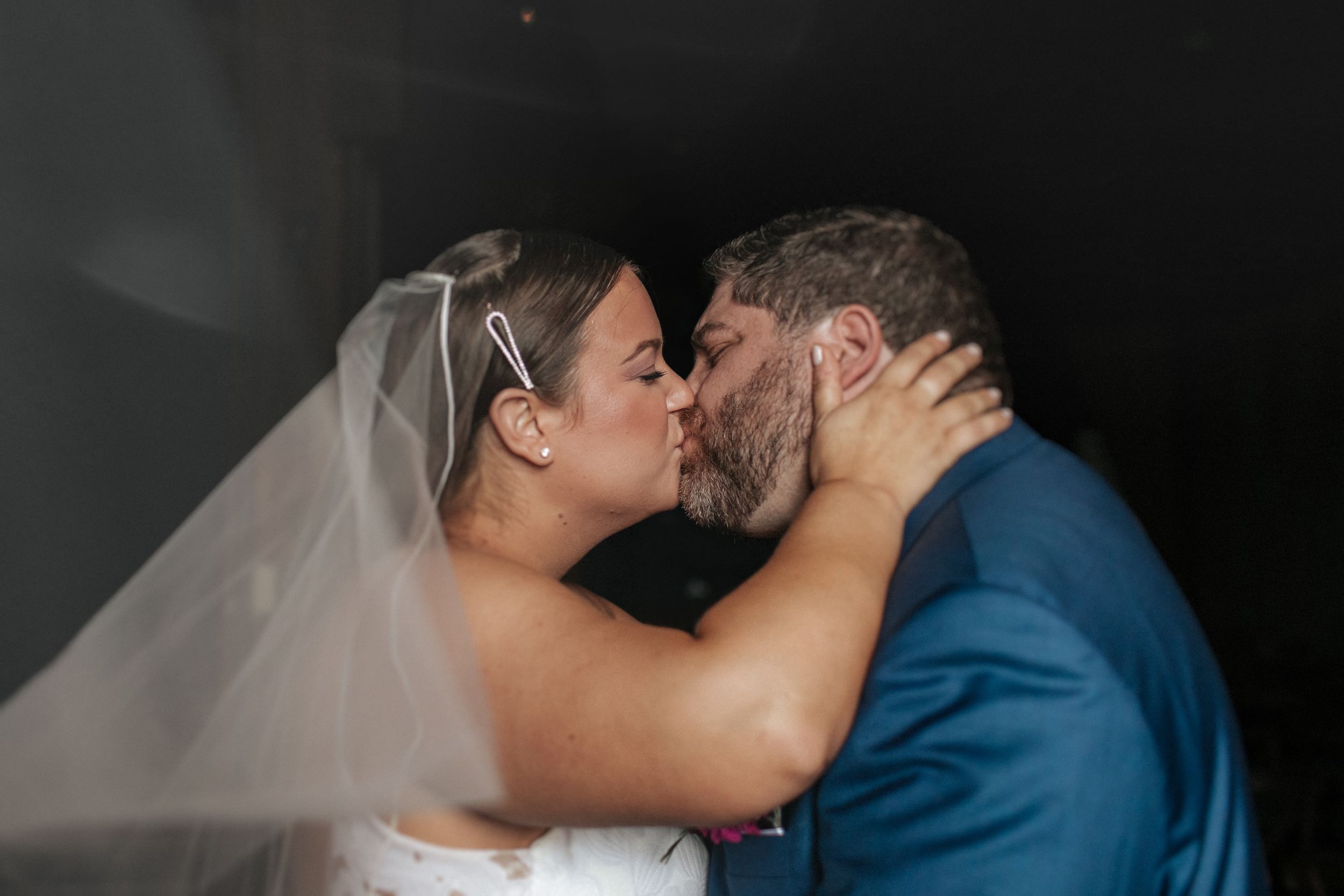Intimate wedding couple sharing romantic kisses in a series of black and white photographs.