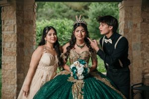Celebratory portrait under stone archway with formal attire.