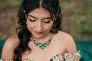 Elegant emerald necklace complements a golden embellished sweetheart neckline.