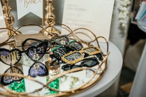 Decorated table with party favors and gold string lights at formal event.