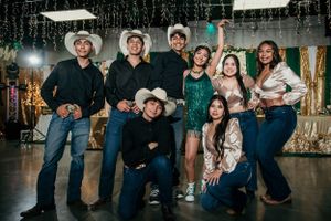 Group photo at a celebration with western attire and formal dress.
