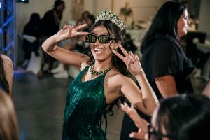 Celebration scene with emerald green attire and decorative crown.