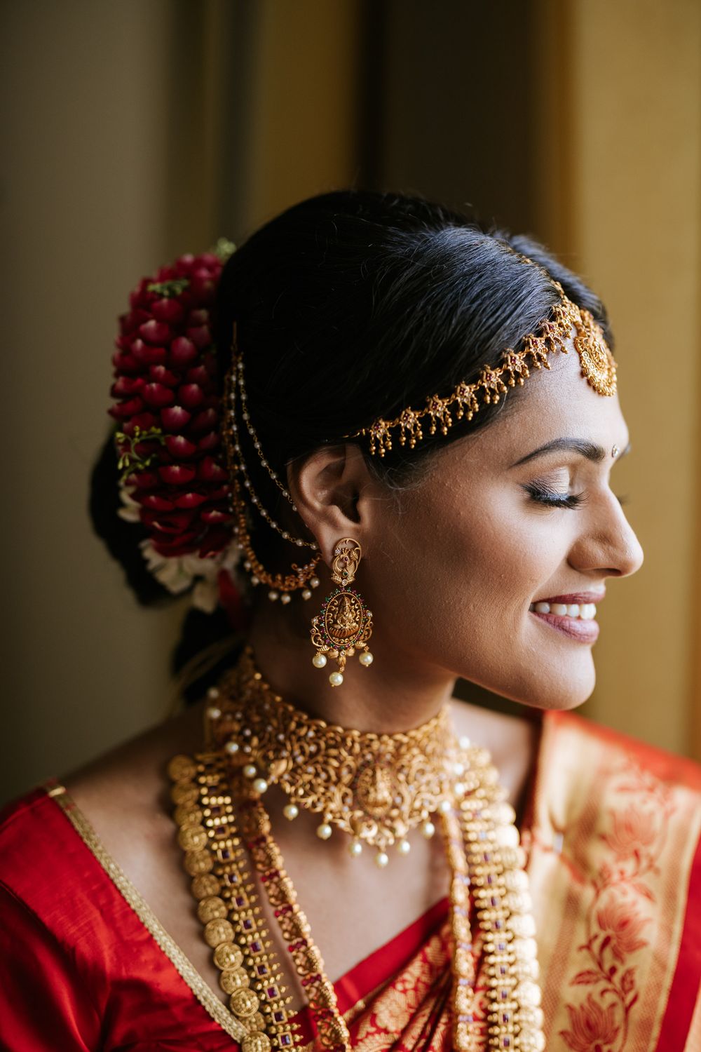 Close-up profile shots of a bride wearing traditional Indian bridal jewelry and red attire.