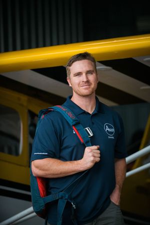 Person in navy uniform with yellow industrial background shown from different angles.