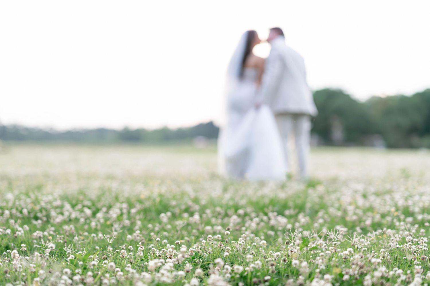 couple blurred with flowers in foreground