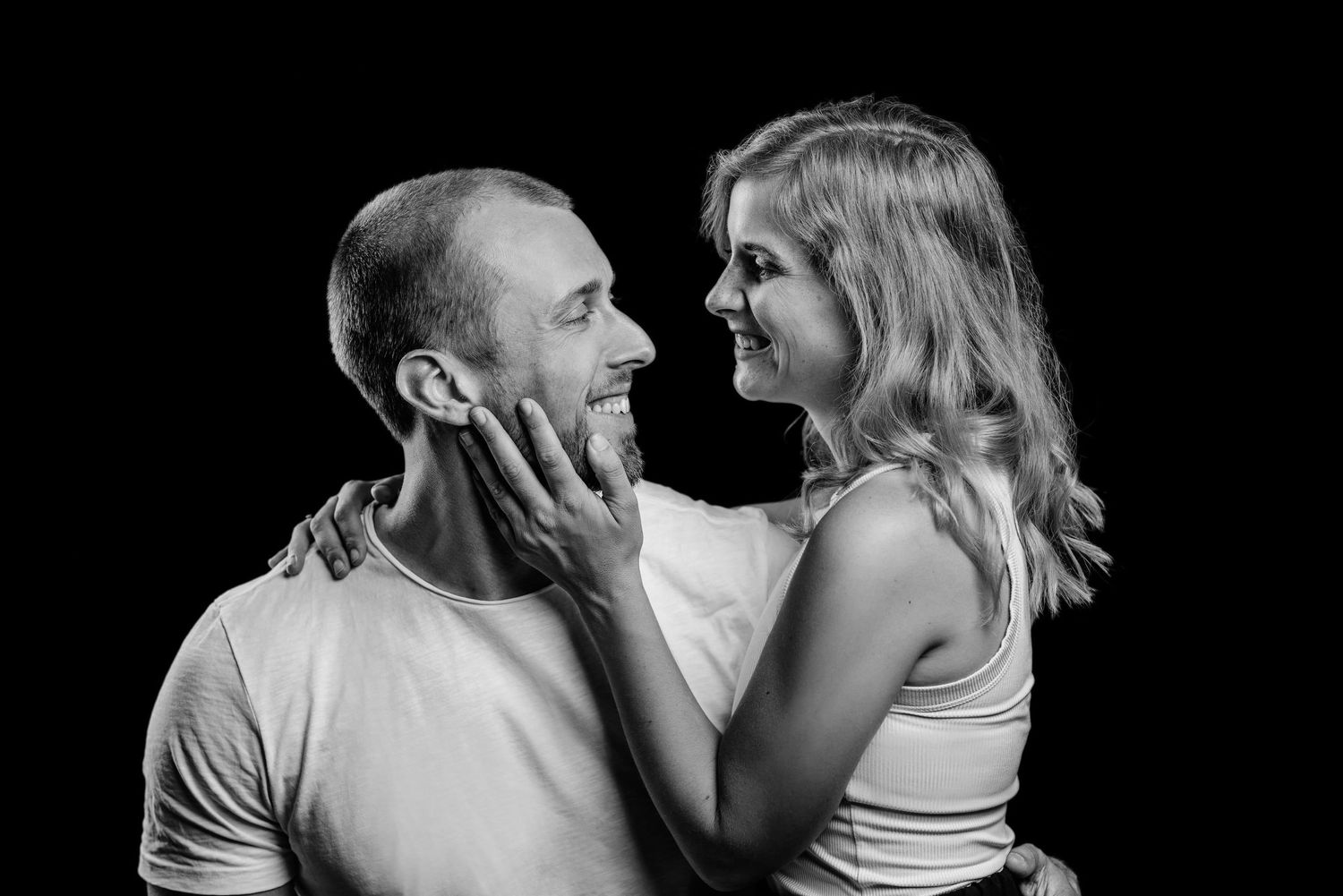 A series of black and white romantic photos showing intimate moments between a couple in silhouette.