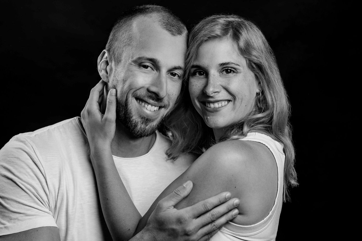 A series of black and white romantic couple photos showing affectionate moments and genuine smiles.
