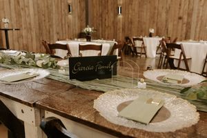 Wedding reception table settings with vintage decor and rustic wooden elements.