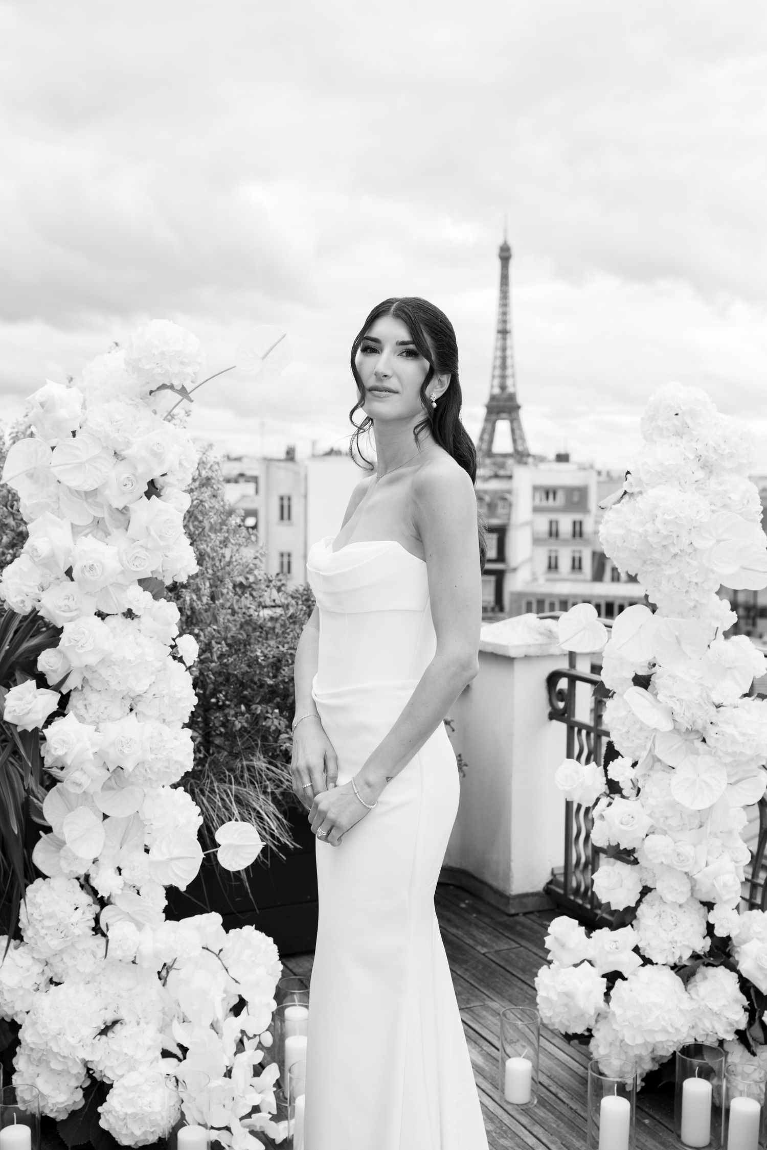 Elegant black and white wedding photos with white floral arrangements and the Eiffel Tower visible in Paris.