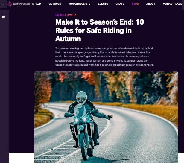 Motorcyclist riding on a winding autumn road with colorful fall foliage in the background.