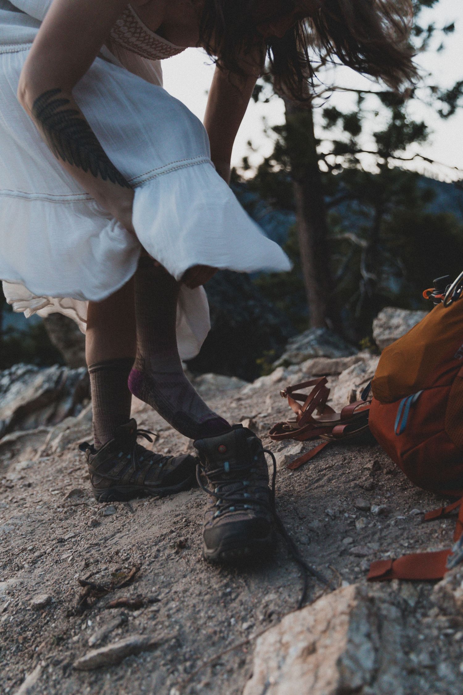 Close-up series of hiking boots and shoes on rocky terrain during an outdoor adventure.