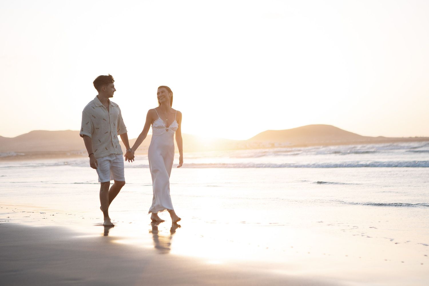 Couple walking on the beach at sunset - Professional wedding and couple photographer in Lanzarote and Fuerteventura photoFuerte