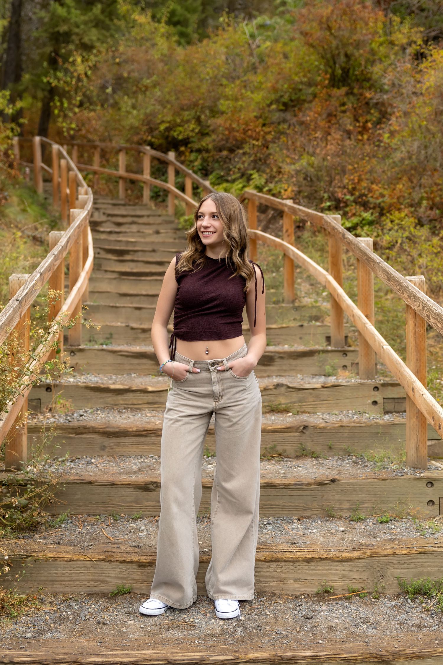 A series of outdoor portraits showing a casual pose on wooden stairs surrounded by autumn foliage.