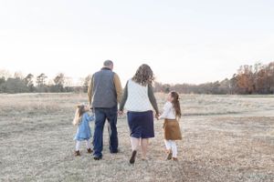 family walking through tall grass