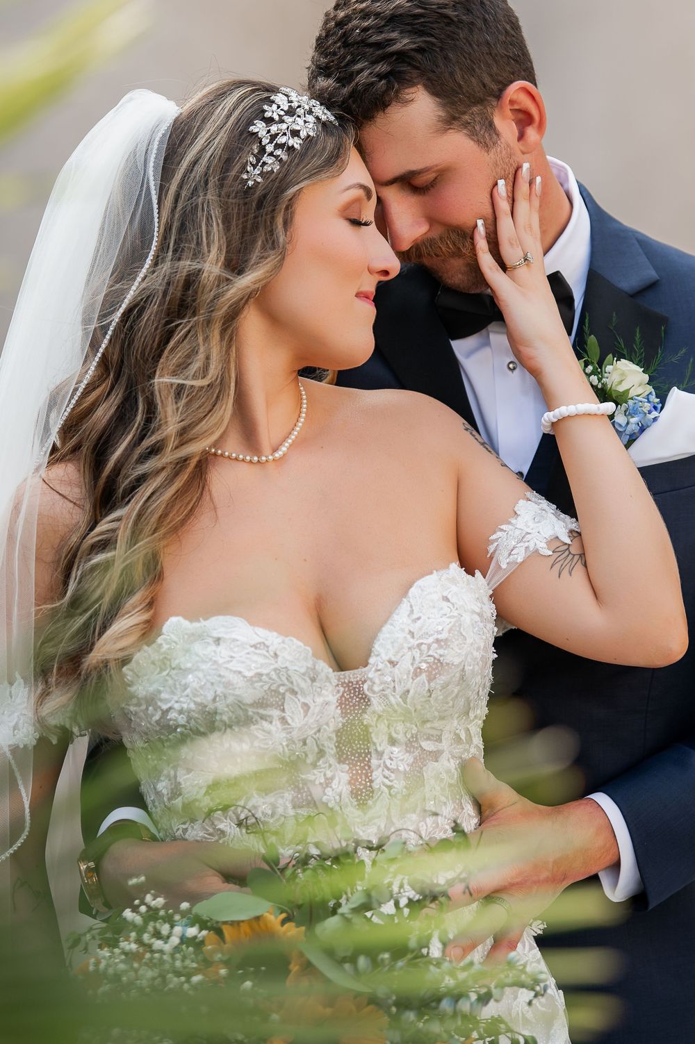 An intimate wedding portrait captures a tender moment between newlyweds.