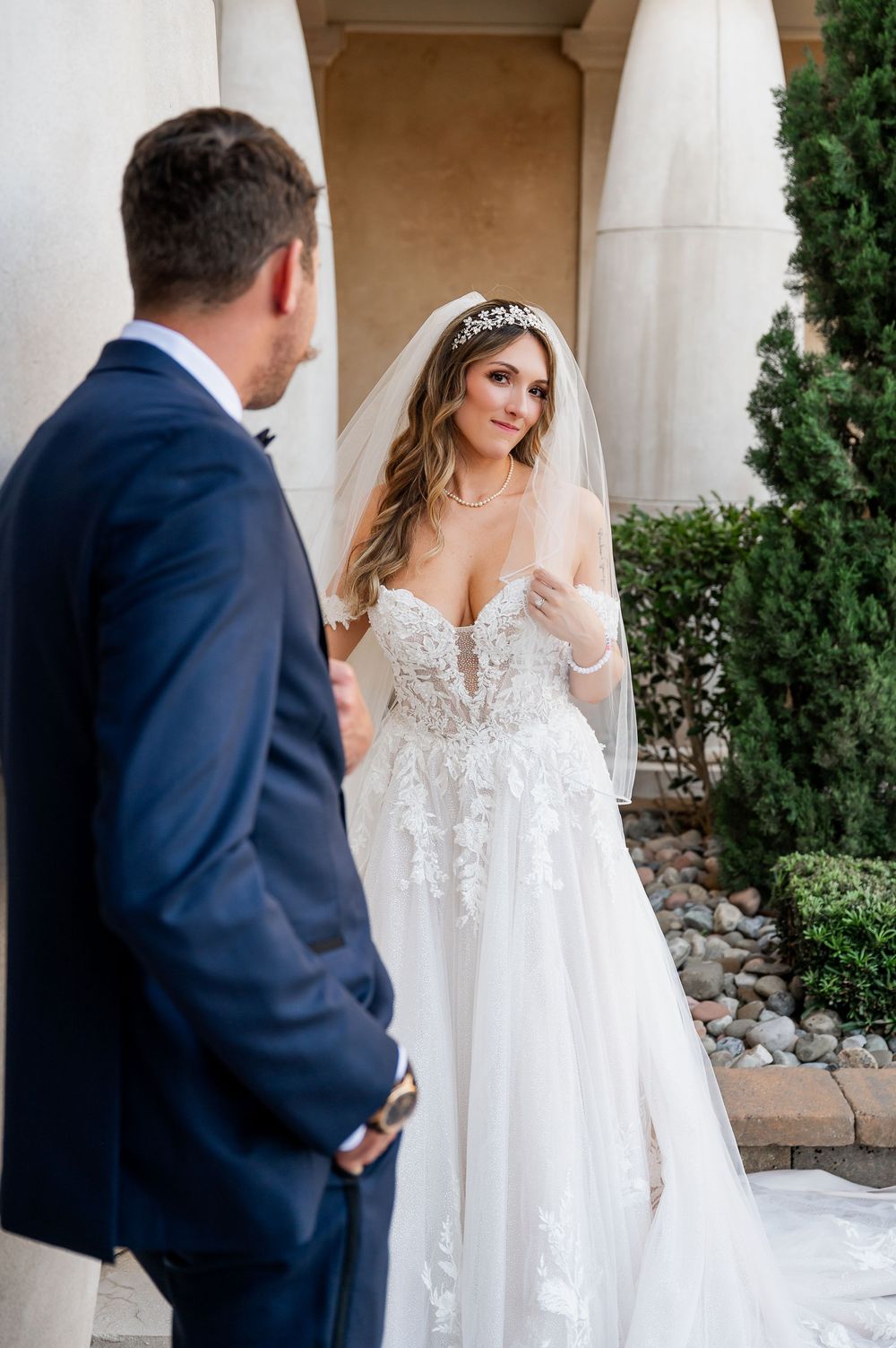 A romantic first look moment between the wedding couple at their elegant venue.