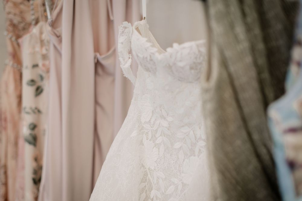 Close-up details of delicate lace on a white wedding gown.