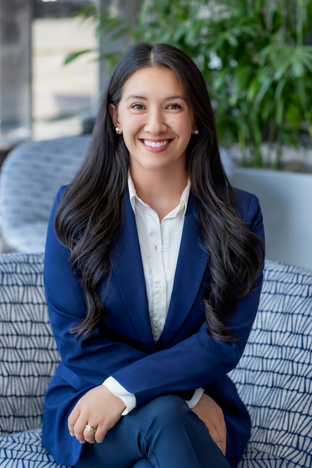 Professional headshot series showing a person in a navy blazer and white blouse against a blurred outdoor background.