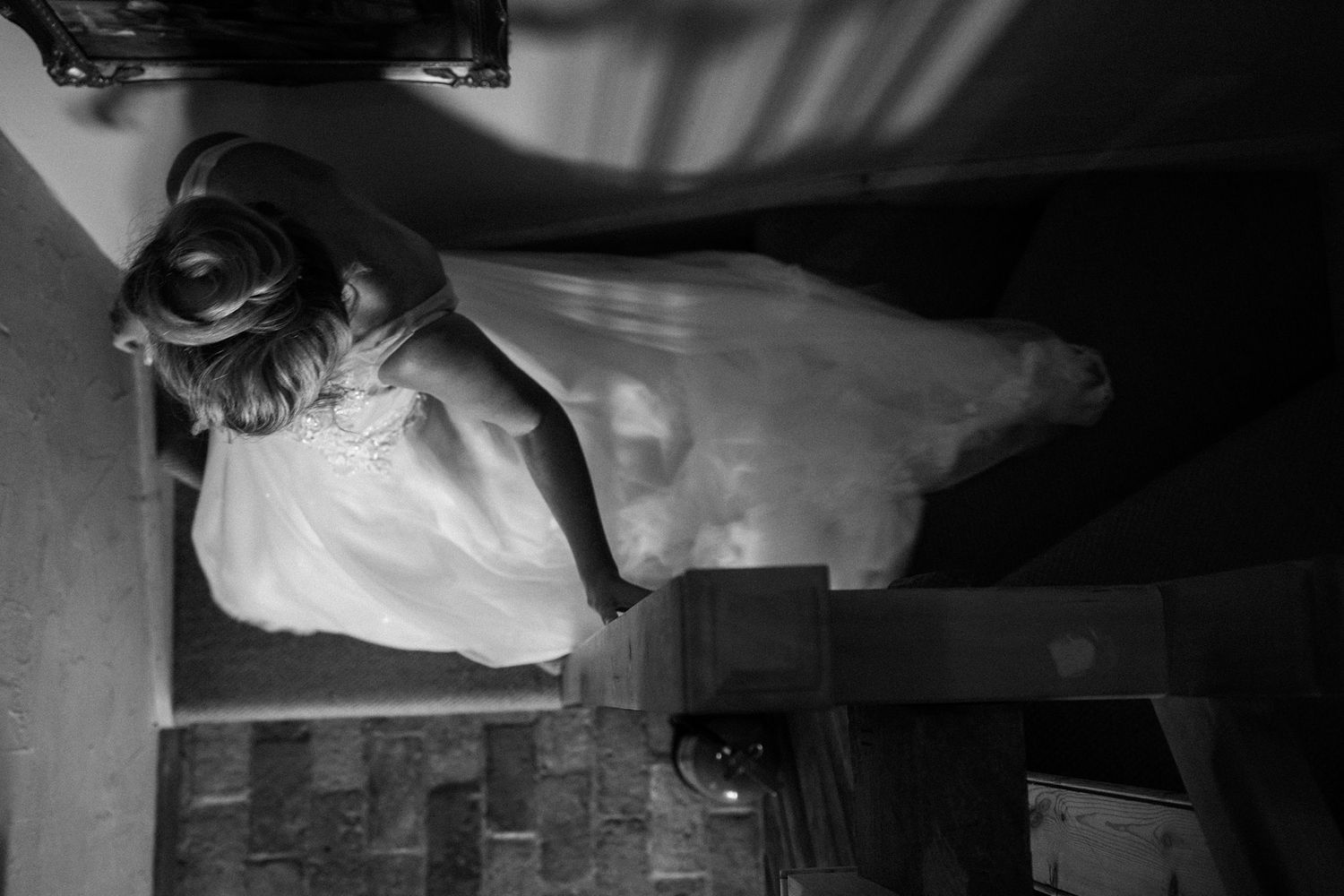 A black and white film noir scene showing a person lying on the ground in dark shadows and dramatic lighting.