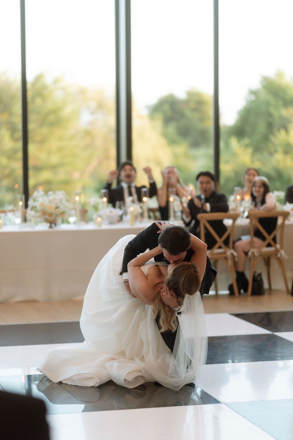 A romantic dance dip sequence at a wedding reception shows a couple in formal attire in an elegant venue.