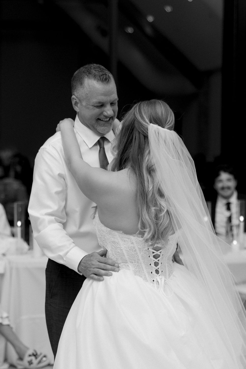 A series of black and white wedding dance photos showing a couple sharing romantic moments on the dance floor.