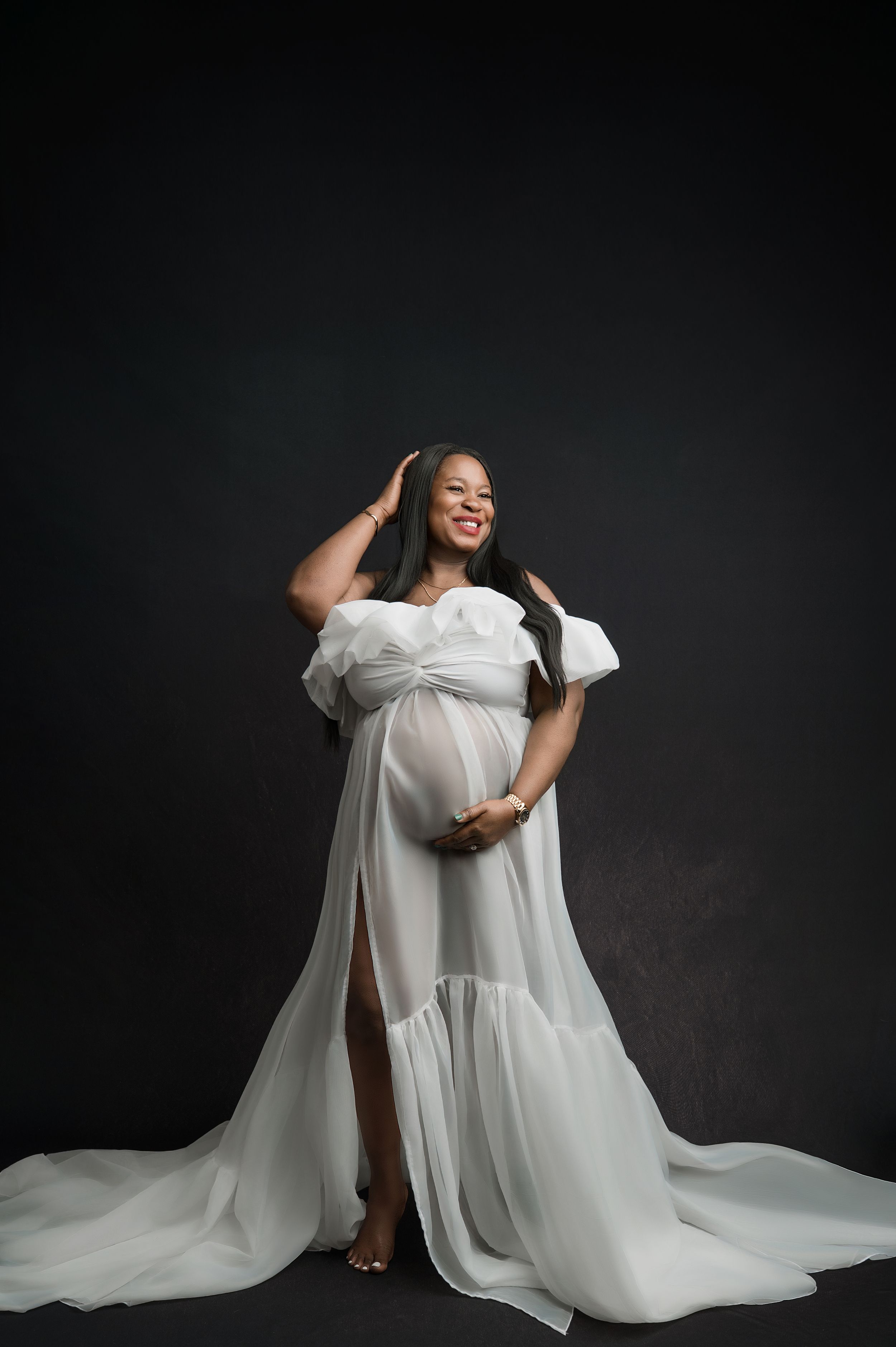 A figure in flowing white fabric poses dramatically against a dark background in a series of artistic portraits.