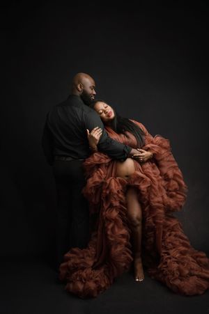 Artistic portrait series showing a figure draped in flowing rust-colored tulle fabric against a dark background.