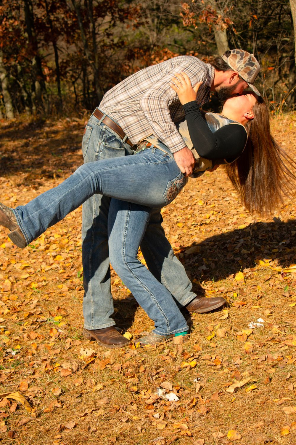 Boyfriend dipping girlfriend for a kiss in front of the Wisconsin fall colors.