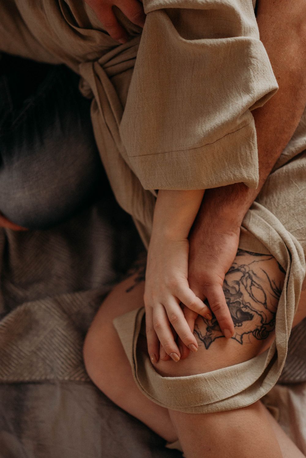 Close-up detail shots of tattoo art visible through flowing fabric.