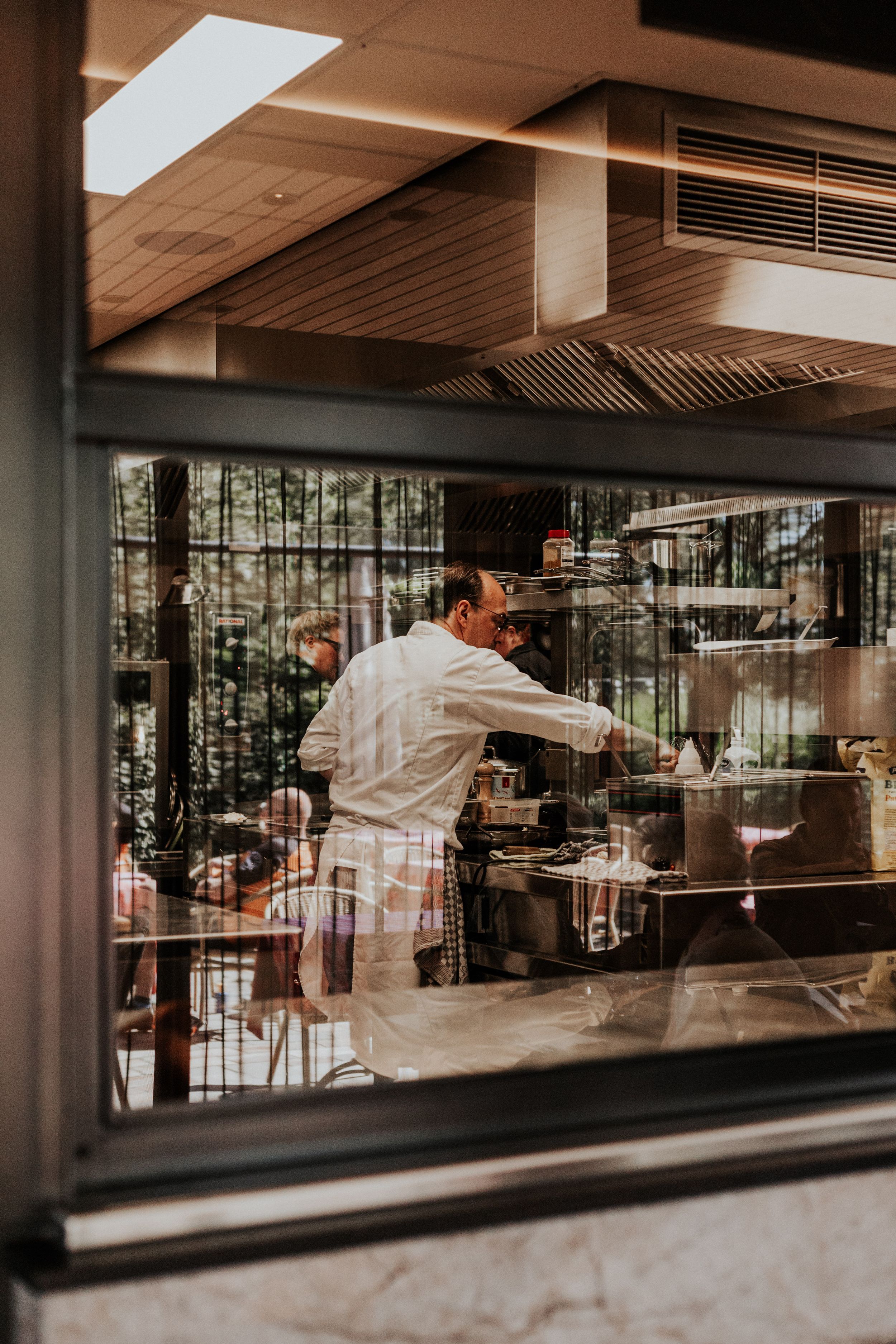 Modern restaurant space with large windows and contemporary design elements.