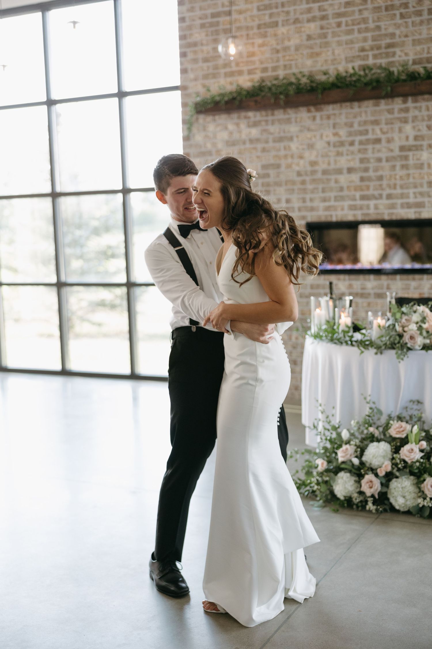 Black and white photo of couple sharing intimate dance moment at reception.